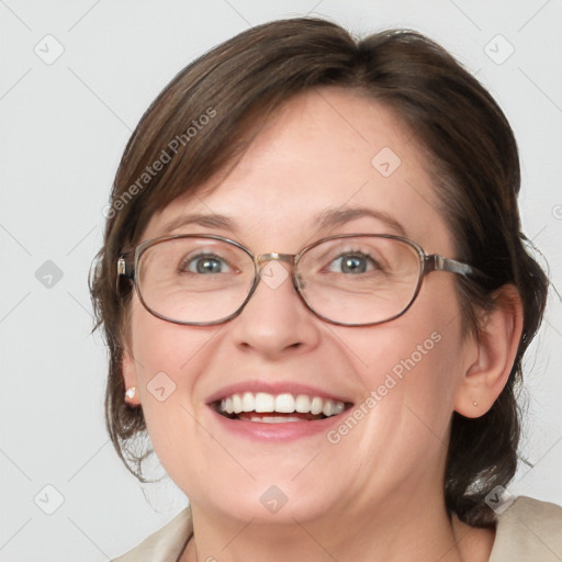 Joyful white adult female with medium  brown hair and blue eyes