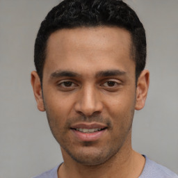 Joyful white young-adult male with short  black hair and brown eyes