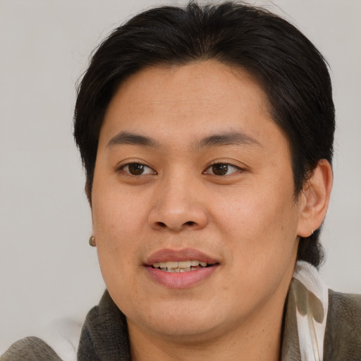 Joyful asian young-adult male with short  brown hair and brown eyes