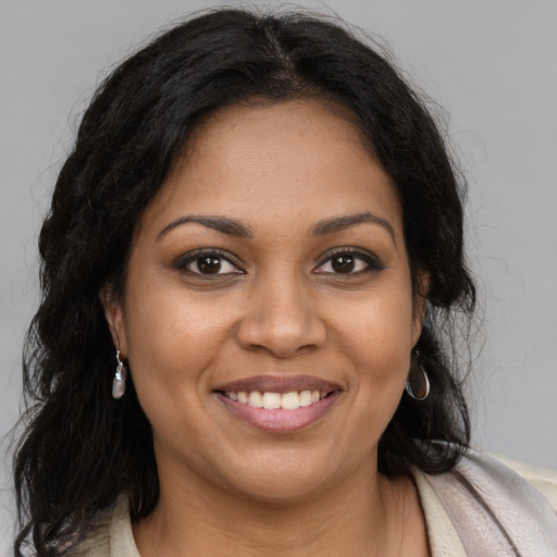 Joyful latino young-adult female with long  brown hair and brown eyes