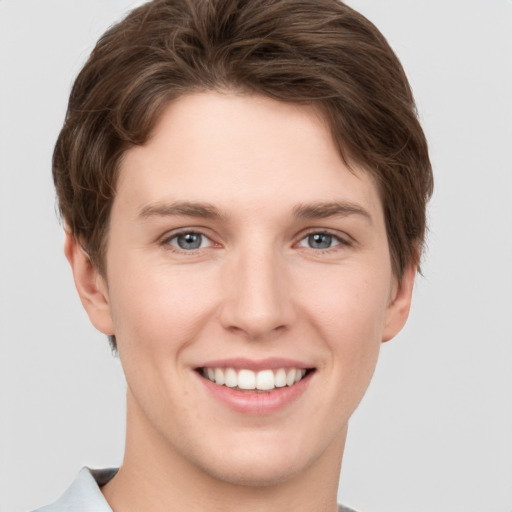 Joyful white young-adult female with short  brown hair and grey eyes