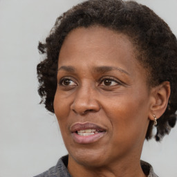 Joyful black adult female with short  brown hair and brown eyes