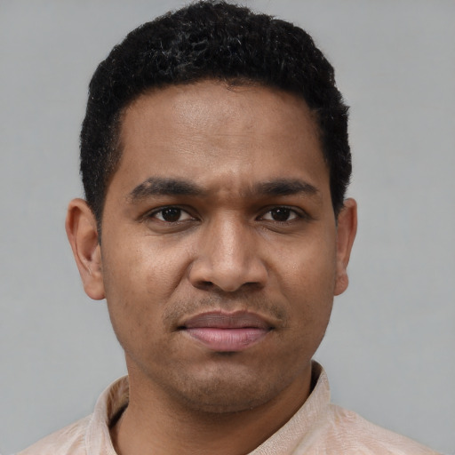 Joyful latino young-adult male with short  brown hair and brown eyes