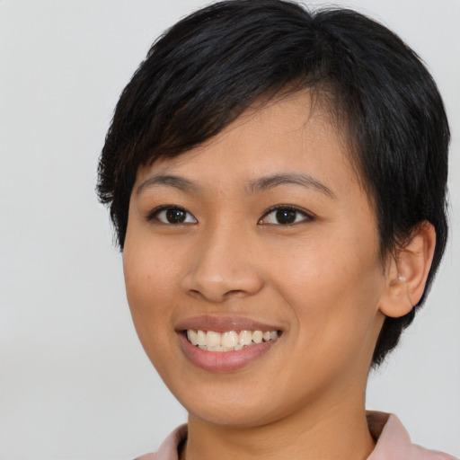 Joyful asian young-adult female with short  brown hair and brown eyes