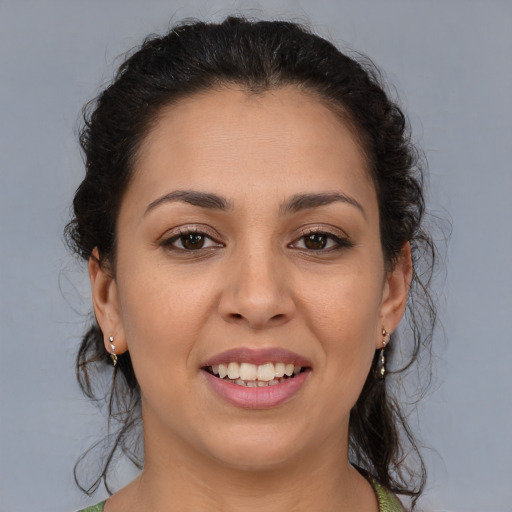 Joyful latino young-adult female with medium  brown hair and brown eyes