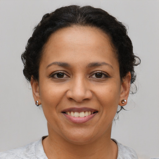 Joyful latino young-adult female with short  brown hair and brown eyes