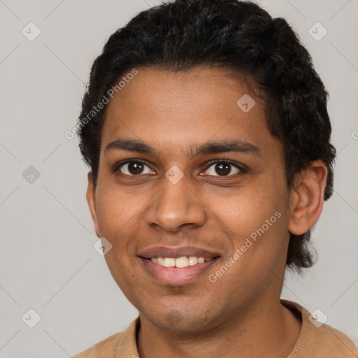 Joyful black young-adult male with short  brown hair and brown eyes