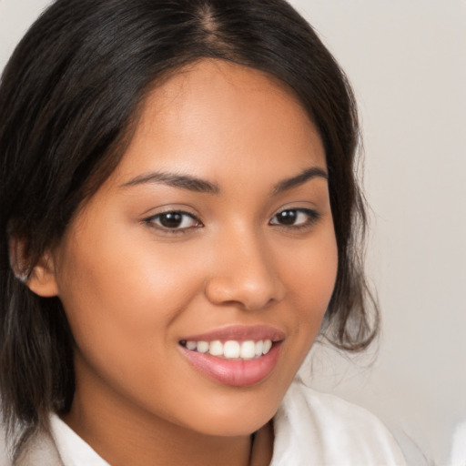 Joyful latino young-adult female with medium  brown hair and brown eyes