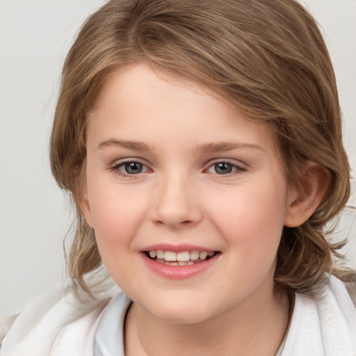 Joyful white child female with medium  brown hair and brown eyes