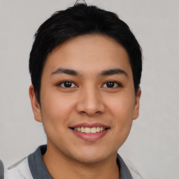 Joyful asian young-adult male with short  black hair and brown eyes