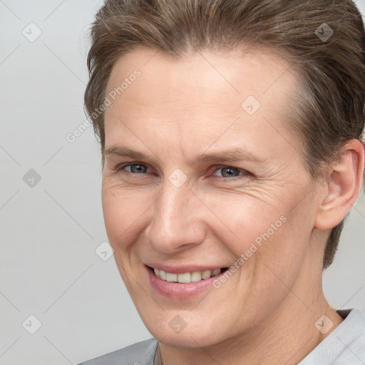 Joyful white adult male with short  brown hair and grey eyes