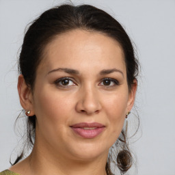 Joyful white adult female with medium  brown hair and brown eyes