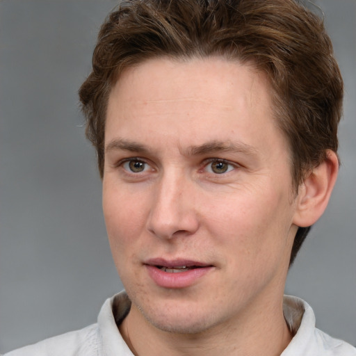 Joyful white adult male with short  brown hair and grey eyes