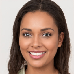 Joyful latino young-adult female with long  brown hair and brown eyes