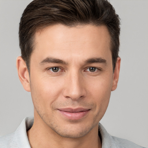 Joyful white young-adult male with short  brown hair and brown eyes