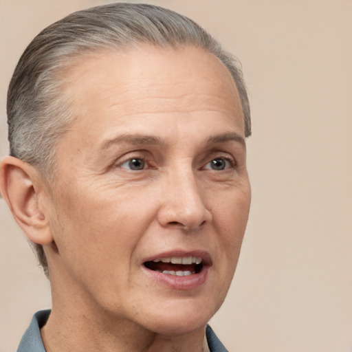 Joyful white middle-aged female with short  gray hair and brown eyes