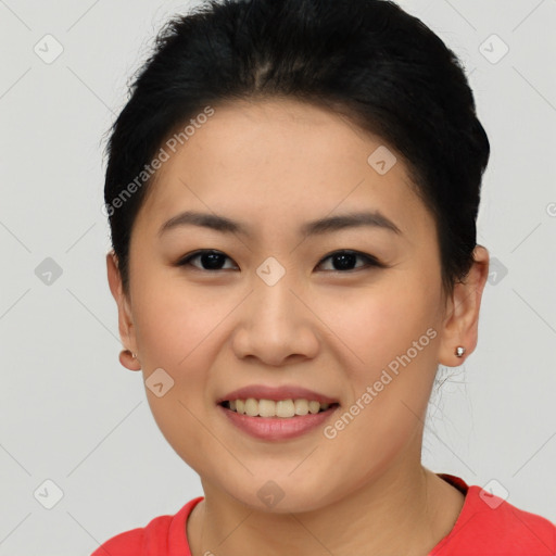 Joyful asian young-adult female with short  brown hair and brown eyes