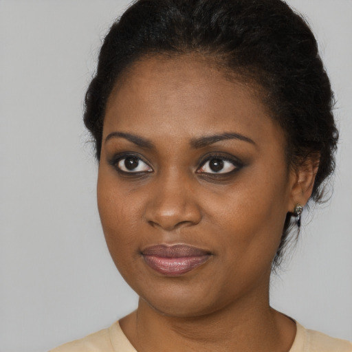 Joyful black young-adult female with medium  brown hair and brown eyes