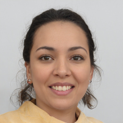 Joyful latino young-adult female with medium  brown hair and brown eyes