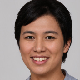 Joyful asian young-adult female with short  black hair and brown eyes