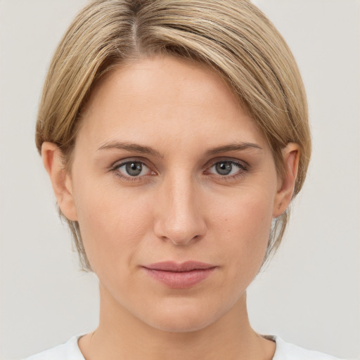 Joyful white young-adult female with medium  brown hair and grey eyes