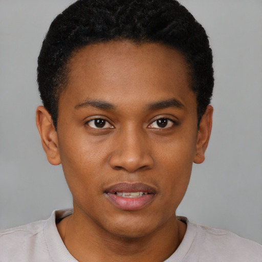 Joyful black young-adult male with short  black hair and brown eyes
