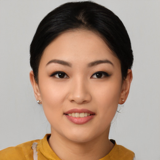Joyful asian young-adult female with short  black hair and brown eyes