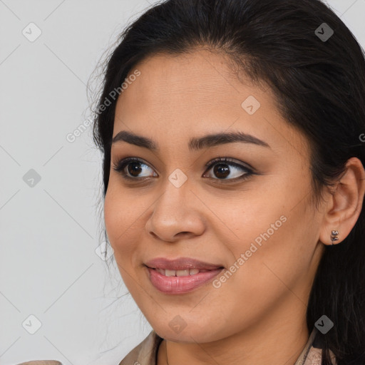 Joyful latino young-adult female with medium  brown hair and brown eyes