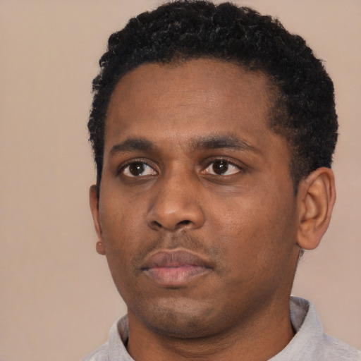 Neutral black young-adult male with short  black hair and brown eyes