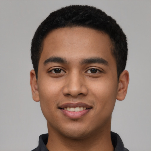 Joyful latino young-adult male with short  black hair and brown eyes