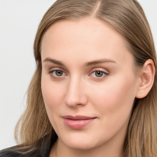 Joyful white young-adult female with long  brown hair and blue eyes