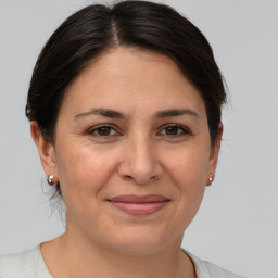 Joyful white adult female with short  brown hair and brown eyes