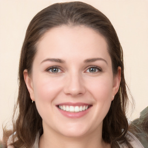 Joyful white young-adult female with long  brown hair and grey eyes