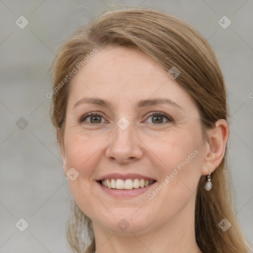 Joyful white adult female with long  brown hair and grey eyes