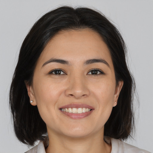 Joyful white young-adult female with medium  brown hair and brown eyes