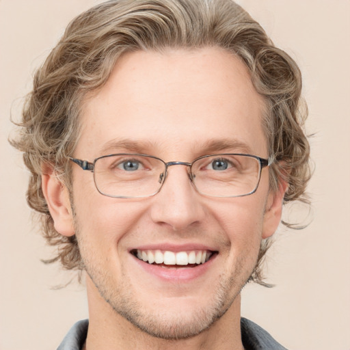 Joyful white adult male with short  brown hair and grey eyes