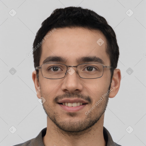 Joyful white young-adult male with short  black hair and brown eyes