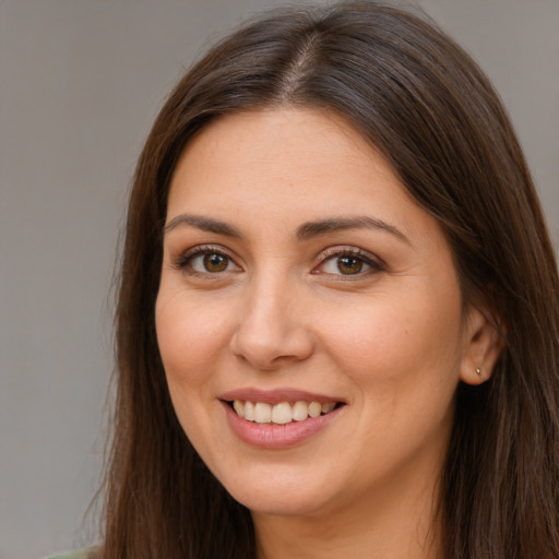 Joyful white young-adult female with long  brown hair and brown eyes