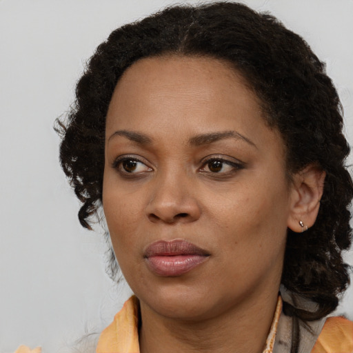 Neutral black young-adult female with medium  brown hair and brown eyes