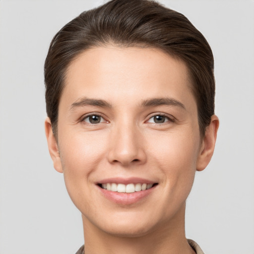 Joyful white young-adult female with short  brown hair and brown eyes