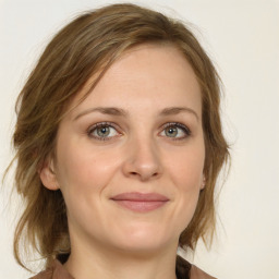 Joyful white young-adult female with medium  brown hair and green eyes