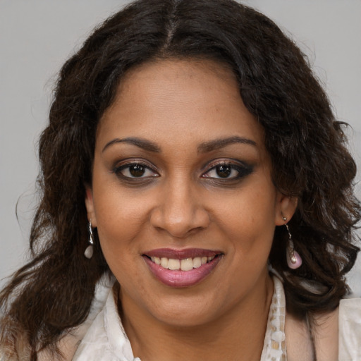 Joyful black young-adult female with medium  brown hair and brown eyes