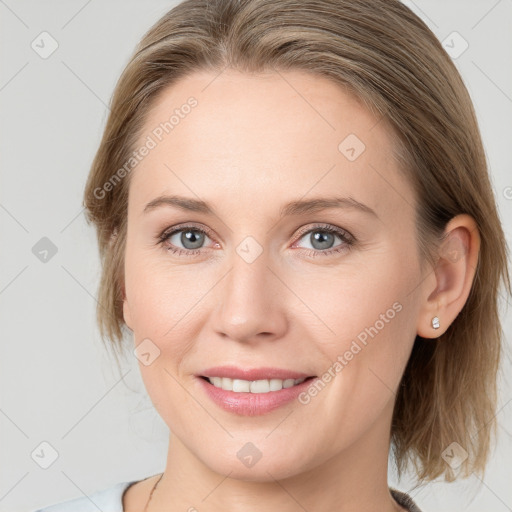 Joyful white young-adult female with medium  brown hair and blue eyes