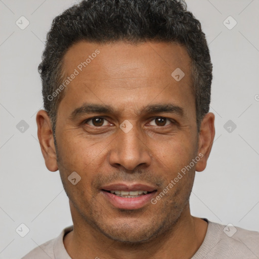 Joyful latino adult male with short  brown hair and brown eyes