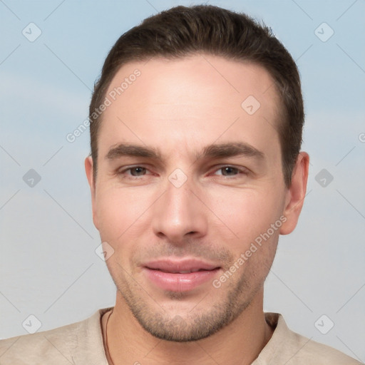 Joyful white young-adult male with short  brown hair and brown eyes