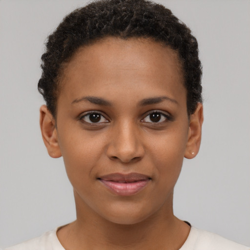 Joyful black young-adult female with short  brown hair and brown eyes