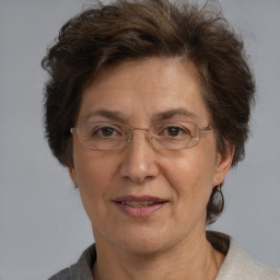 Joyful white middle-aged female with medium  brown hair and brown eyes