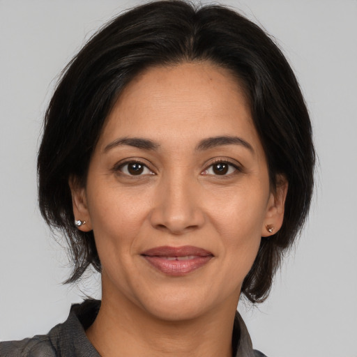 Joyful white adult female with medium  brown hair and brown eyes