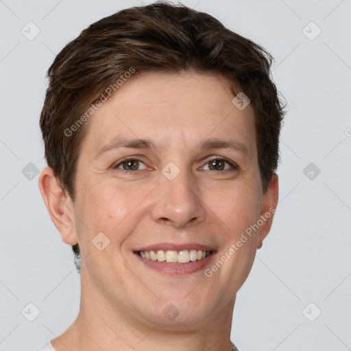 Joyful white adult female with short  brown hair and grey eyes