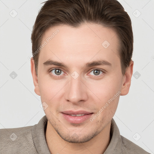 Joyful white young-adult male with short  brown hair and grey eyes